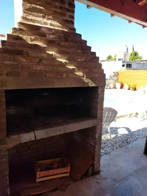 an outdoor brick fireplace with a pizza box at Cabañas los materos 2 in Cordoba
