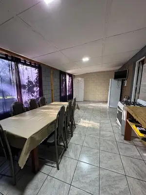 a room with a long table and chairs in it at Cabañas misueño in Villa Ciudad de America
