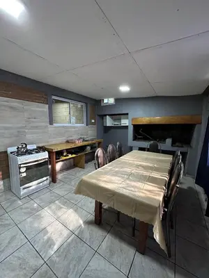 a kitchen with a table and a stove in a room at Cabañas misueño in Villa Ciudad de America