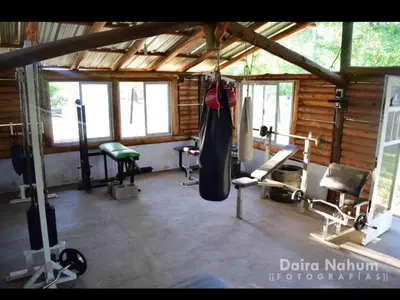 a gym with some equipment in a room at Cabañas misueño in Villa Ciudad de America