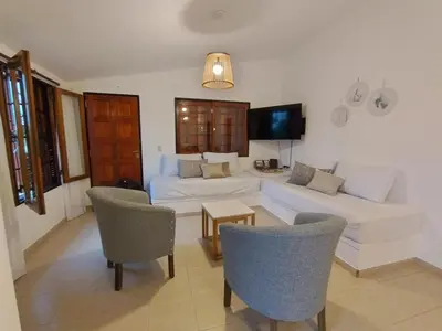 a living room with a couch and a table at Casa con pileta cómoda y equipada in Villa Carlos Paz