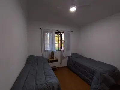 a bedroom with two beds and a window at Casa con pileta cómoda y equipada in Villa Carlos Paz