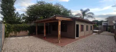 a small building with a roof on a brick yard at Casa El Aromito Anisacate in Villa Anizacate