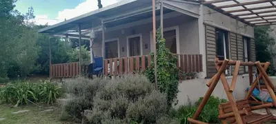 a small house with a porch and a fence at Alquiler temporario tanti in Villa Carlos Paz