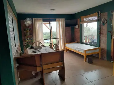 a bedroom with a bed and a desk in a room at Alquiler temporario tanti in Villa Carlos Paz
