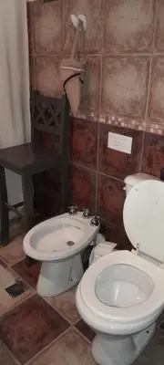 a bathroom with a toilet and a sink at Alquiler temporario tanti in Villa Carlos Paz