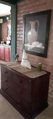 a wooden dresser with a vase on top of it at Alquiler temporario tanti in Villa Carlos Paz