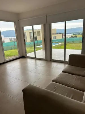 a living room with a couch and sliding glass doors at Home in Puerto del Águila in La Estancia