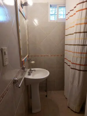 a bathroom with a sink and a mirror and a shower at Mirador de estrellas in Villa Rumipal