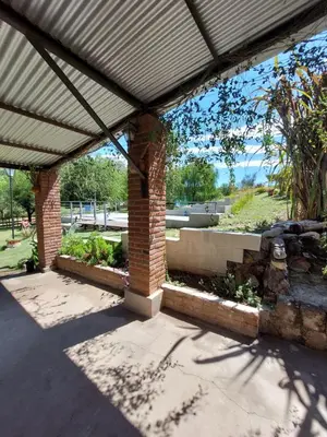 a brick building with a roof with a patio at Mirador de estrellas in Villa Rumipal