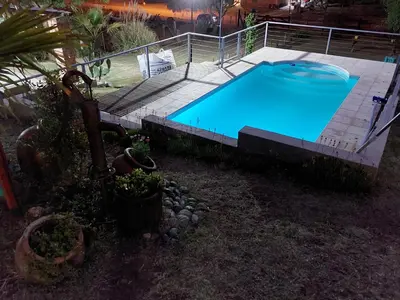 an empty swimming pool in a yard with a fence at Mirador de estrellas in Villa Rumipal