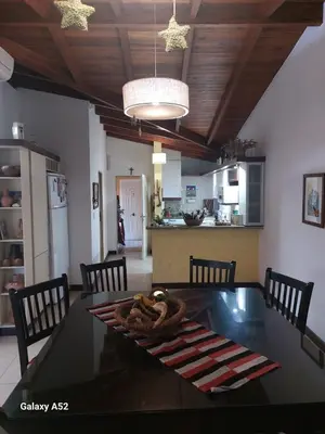 a kitchen and dining room with a table and chairs at Departamento en Barrio Santa Rita in Villa Carlos Paz