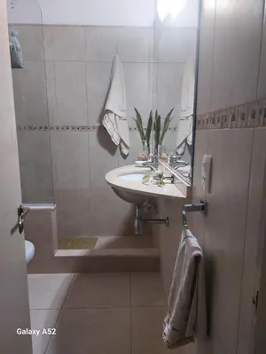a bathroom with a sink and a mirror at Departamento en Barrio Santa Rita in Villa Carlos Paz