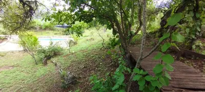 a wooden stairway leading to a pool in a park at Cabaña La Peulla in Cuesta Blanca