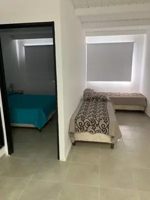 a bedroom with a bed and a mirror at El Jorgito in Villa Carlos Paz