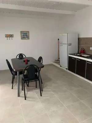 a kitchen with a table and chairs in a room at El Jorgito in Villa Carlos Paz