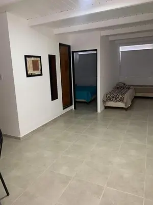 a large room with a bed and a tiled floor at El Jorgito in Villa Carlos Paz