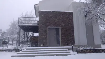a brick building with stairs in the snow at Rumbo 020 Apart in Merlo