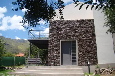 a building with stairs leading to a door at Rumbo 020 Apart in Merlo