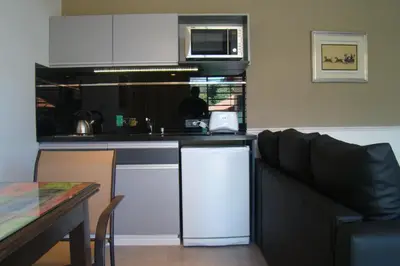 a kitchen with a couch and a counter top at Rumbo 020 Apart in Merlo