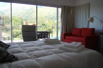 a large bed in a room with a large window at Rumbo 020 Apart in Merlo