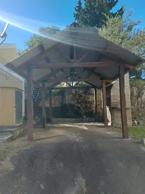 a large wooden pavilion in a parking lot at Cabaña Aikén in Embalse