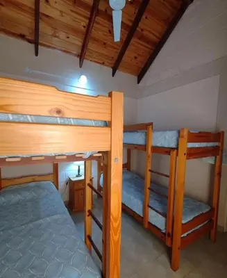 a bedroom with two bunk beds in a room at Cabaña Aikén in Embalse
