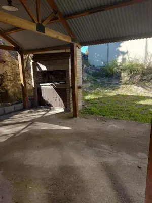 an empty garage with awning and a building at Cabaña Aikén in Embalse