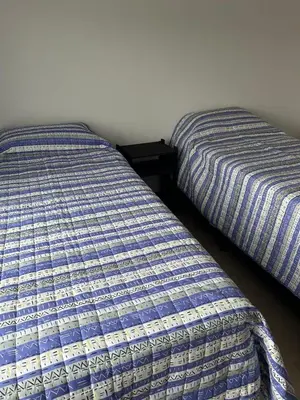 two beds sitting next to each other in a room at Puerto del Águila home in La Estancia