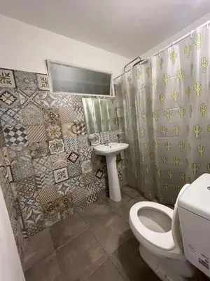 a bathroom with a toilet and a sink at Casa con pileta a 2 cuadras del río in San Antonio de Arredondo