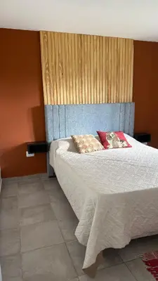 a bedroom with a bed with two pillows on it at Casa con pileta a 2 cuadras del río in San Antonio de Arredondo