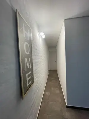 a hallway with a sign on a wall at Casa con pileta a 2 cuadras del río in San Antonio de Arredondo