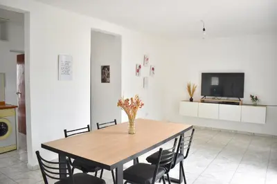 a dining room with a wooden table and chairs at Secret Garden in San Antonio de Arredondo