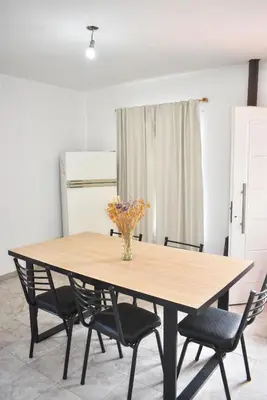 a dining room table with chairs and a vase of flowers at Secret Garden in San Antonio de Arredondo
