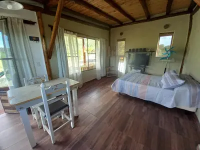 a bedroom with a bed and a desk in a room at Balcón Natural in Los Hornillos