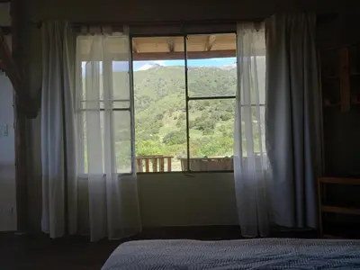 a bedroom with a window with a view of a mountain at Balcón Natural in Los Hornillos