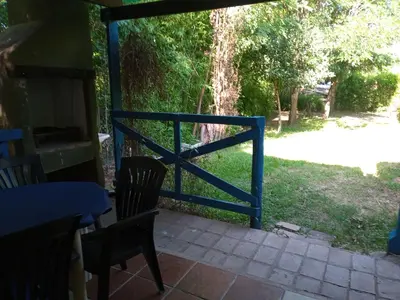 a blue fence on a patio with a table and chairs at La Rinconada Nono in Nono