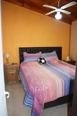 a bedroom with a bed with a soccer ball on it at Oasis casa de descanso in Villa Carlos Paz