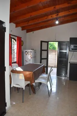 a kitchen with a table and chairs and a refrigerator at Oasis casa de descanso in Villa Carlos Paz