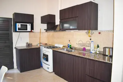 a kitchen with a sink and a stove top oven at Oasis casa de descanso in Villa Carlos Paz