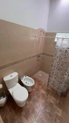 a bathroom with a toilet and a shower at Apart La Ideal in Villa Cura Brochero