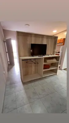 a living room with a flat screen tv in a cabinet at Apart La Ideal in Villa Cura Brochero