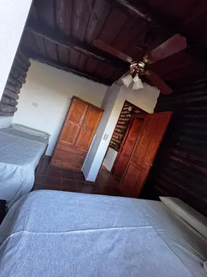 a bedroom with two beds and a ceiling fan at Amanecerenunsueñoyacanto in El Durazno