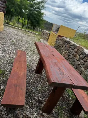 two wooden benches sitting on top of a stone wall at Amanecerenunsueñoyacanto in El Durazno