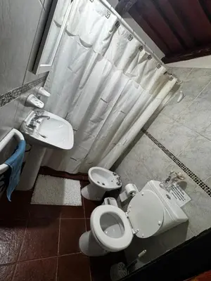 a bathroom with a toilet and a sink and a shower at Amanecerenunsueñoyacanto in El Durazno
