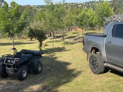 a four wheeler parked next to a truck at Amanecerenunsueñoyacanto in El Durazno