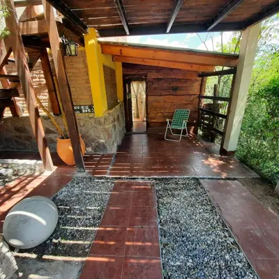 a screened in porch of a house with a chair at La luisa segunda in Villa Parque Siquiman
