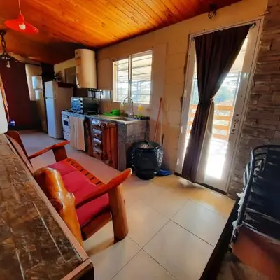 a room with a kitchen with a table and a counter at La luisa segunda in Villa Parque Siquiman
