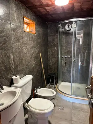 a bathroom with a toilet a sink and a shower at La luisa segunda in Villa Parque Siquiman