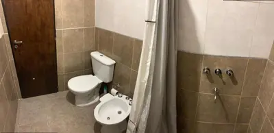 a bathroom with a toilet and a shower at Depto Palmar in Villa Carlos Paz